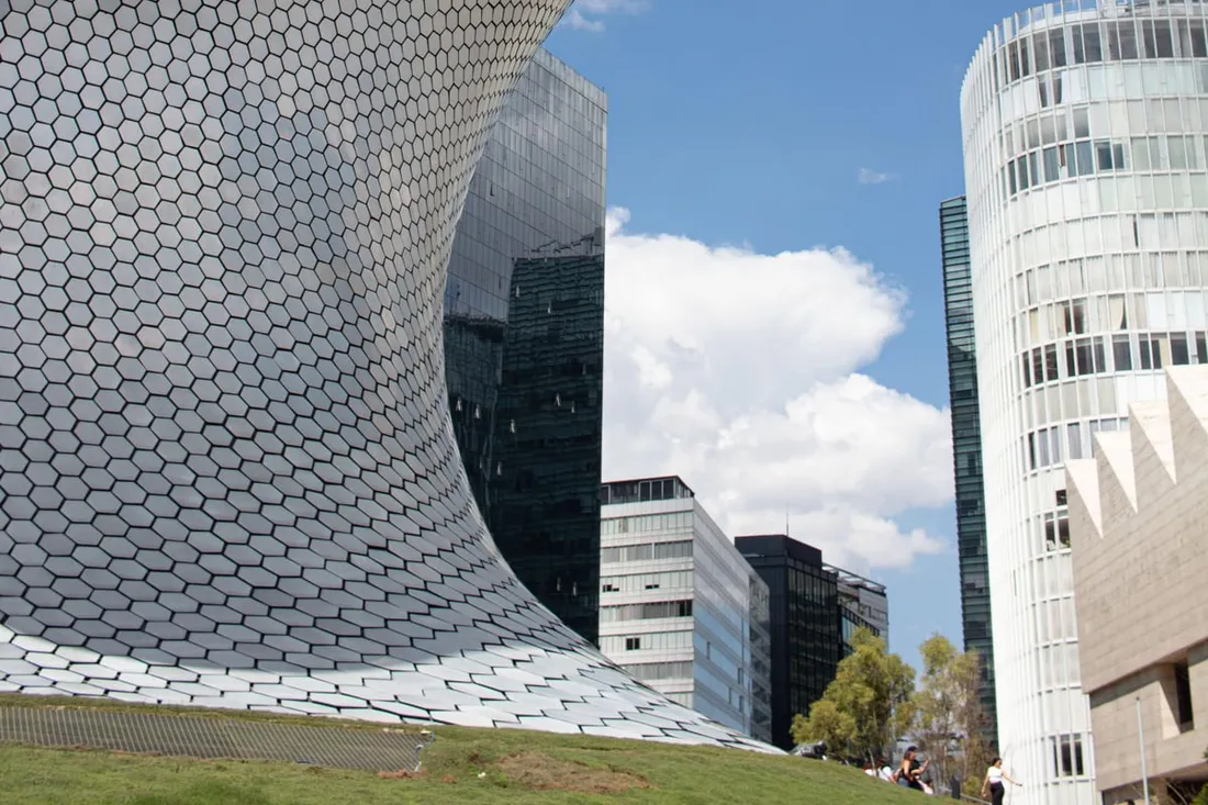 Sculptures inside the silver hexagonal-tiled building on a museo soumaya guided tour in Mexico City